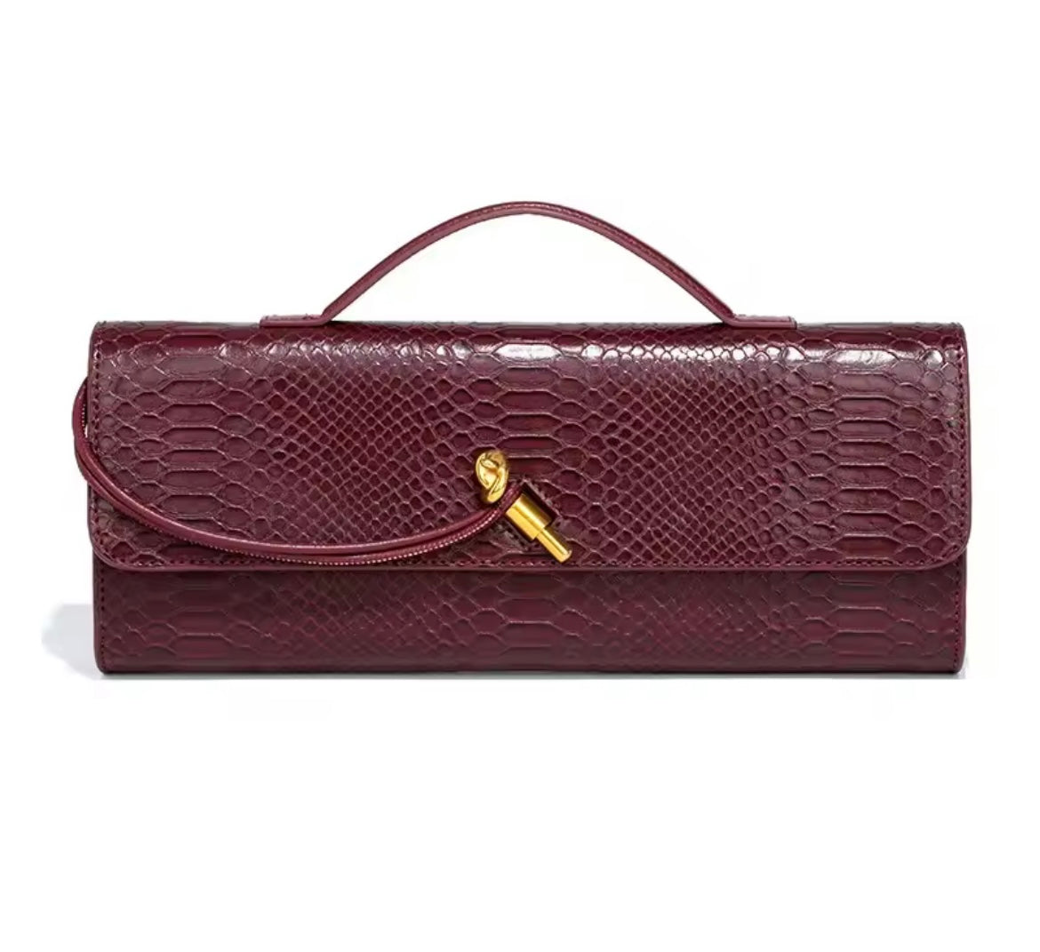 Luxurious clutch bag in crocodile look