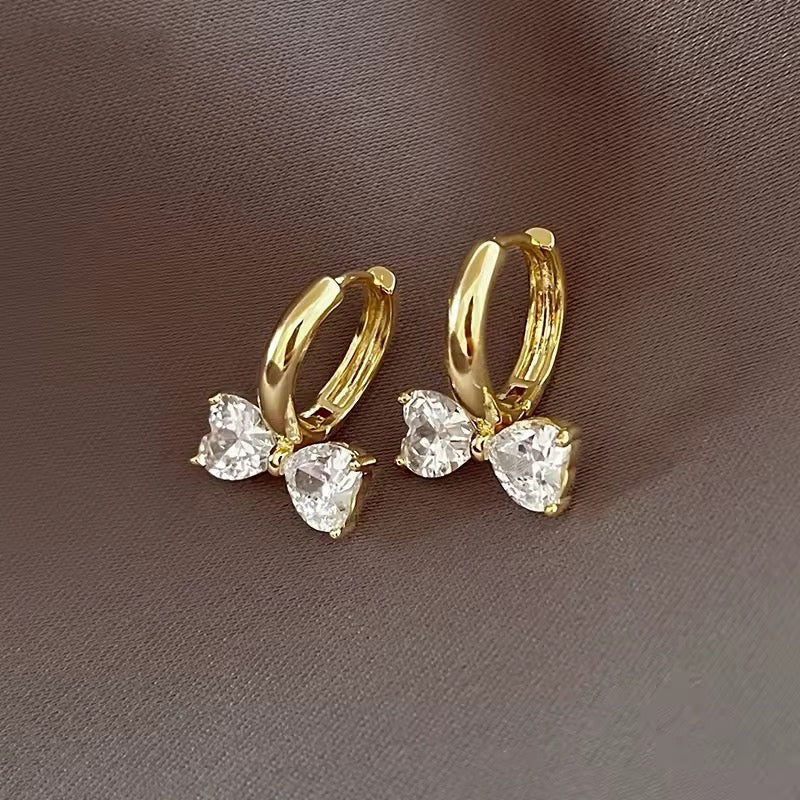 Hoop earrings with bow pendant and sparkling zirconia stones